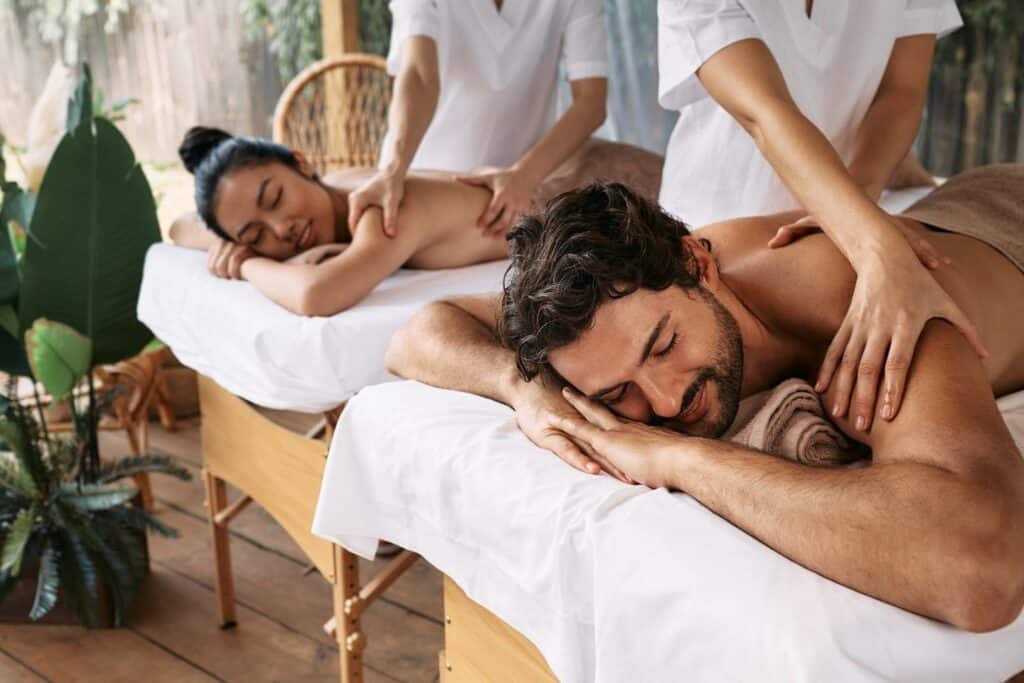 A couple receiving a relaxing massage at a serene spa, perfect for expectant parents on a babymoon in New Orleans
