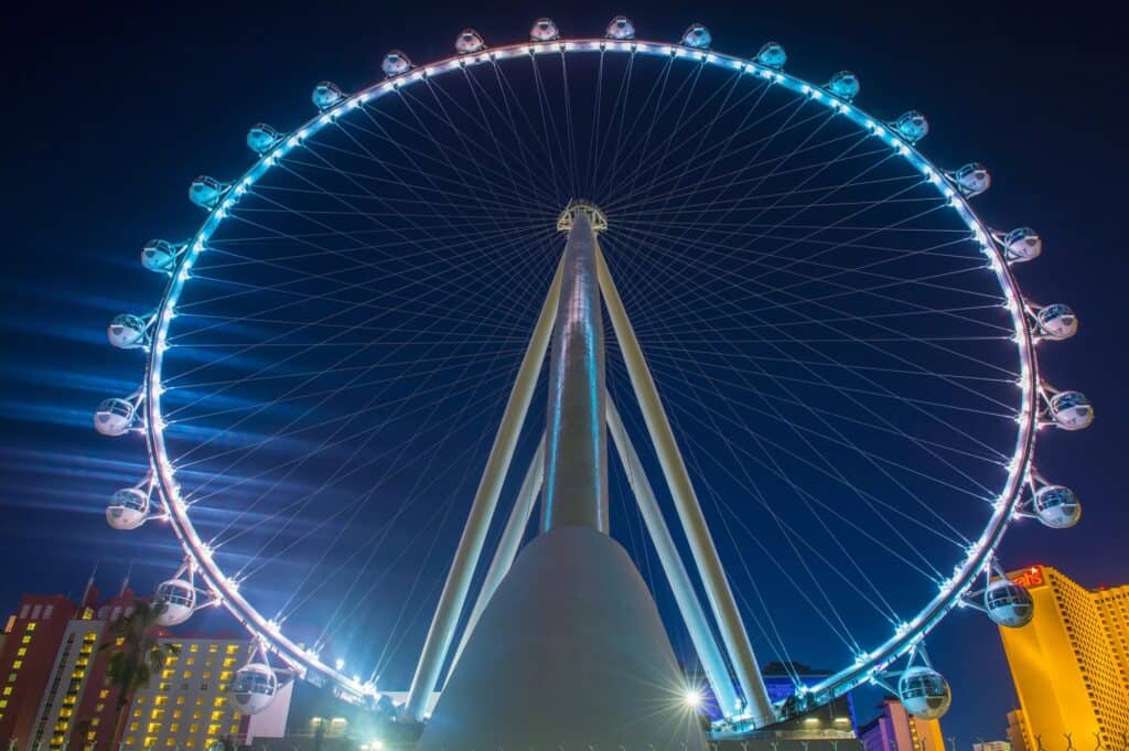 The High Roller Ferris wheel lights up the night sky in Las Vegas, a must-visit attraction for couples on a babymoon in Las Vegas, offering panoramic city views