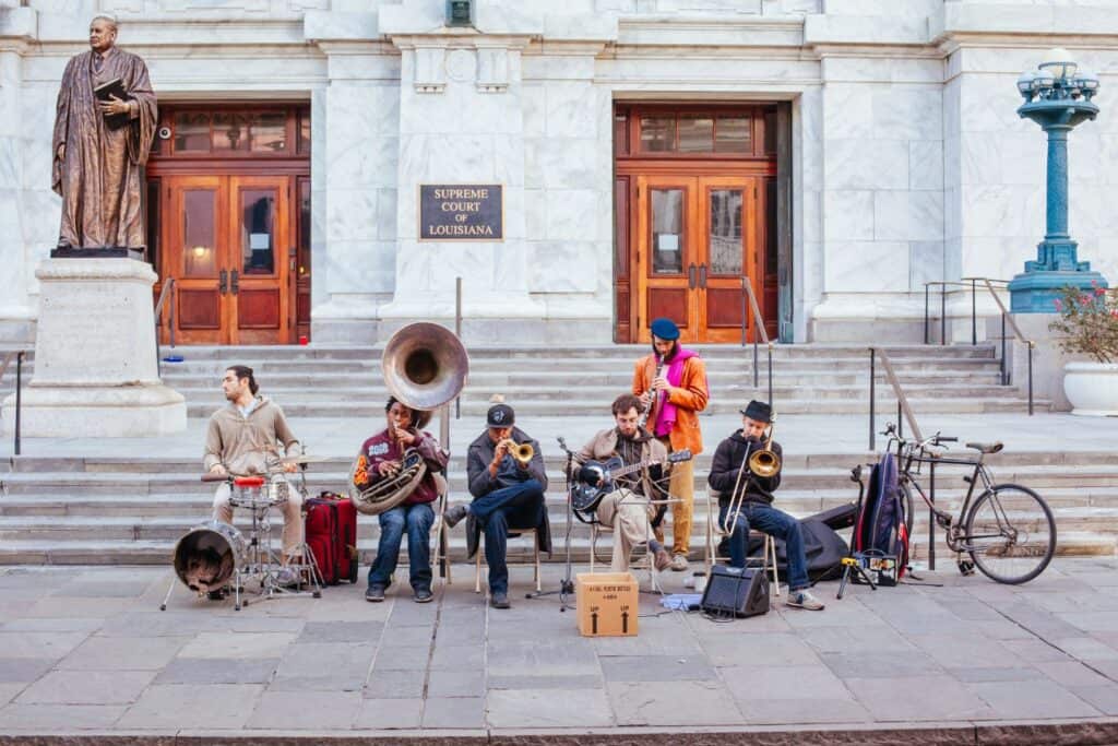 A live jazz band performing on the steps of the Louisiana Supreme Court, capturing the musical essence of a New Orleans babymoon