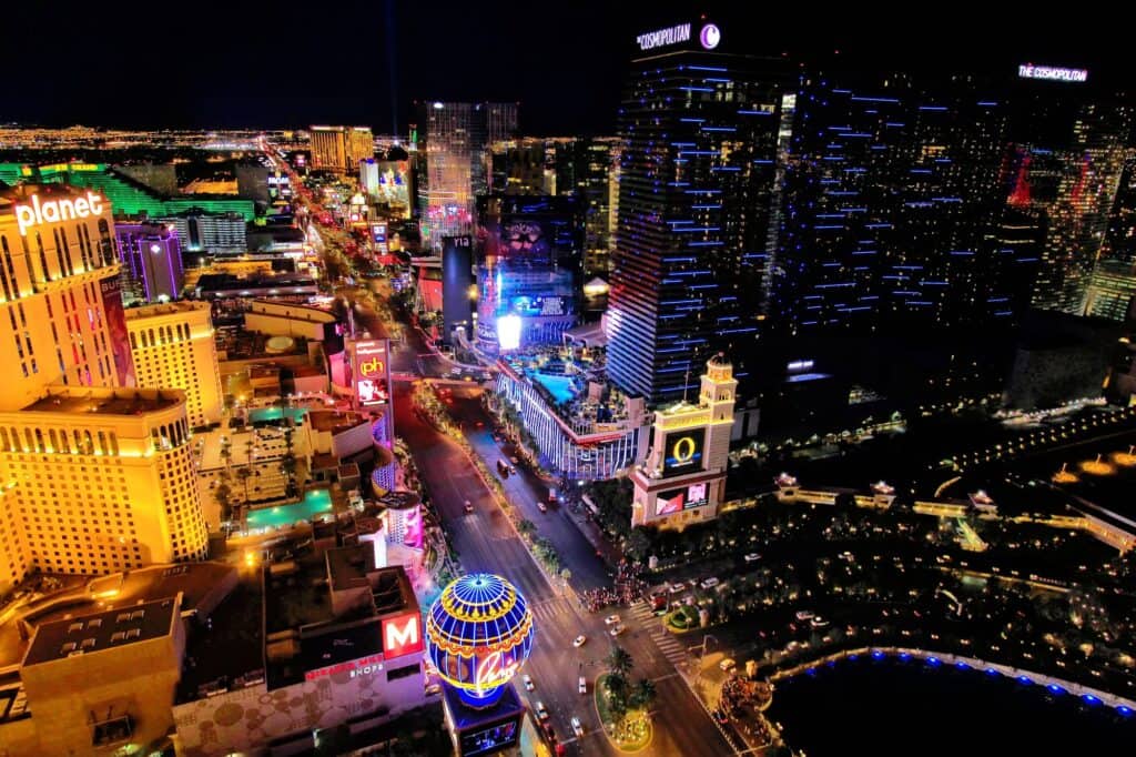 A vibrant aerial view of the Las Vegas Strip at night, glittering with lights and bustling with activity, perfect for an exciting Las Vegas babymoon adventure