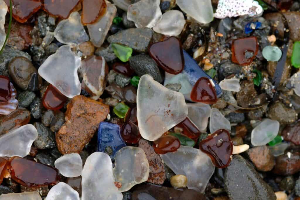 Close-up of colorful sea glass pieces on the Mendocino coast, a unique natural wonder to explore during a babymoon in California