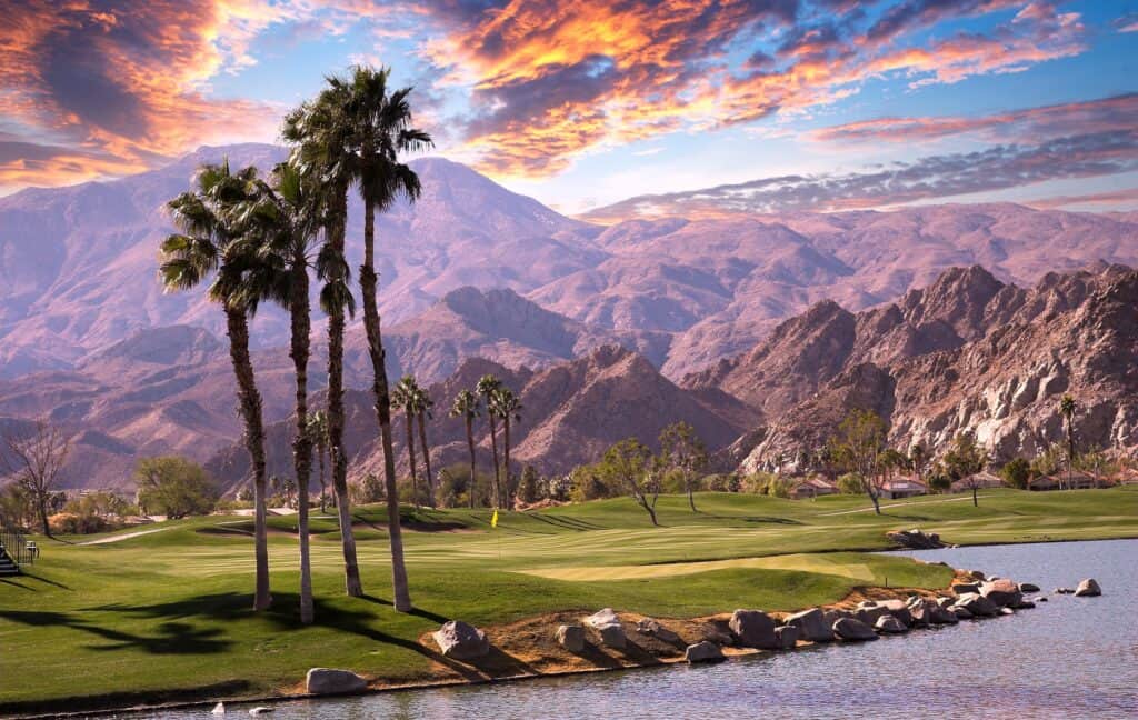 Sunset over a picturesque Palm Springs golf course, reflecting the serene beauty ideal for a relaxing babymoon.