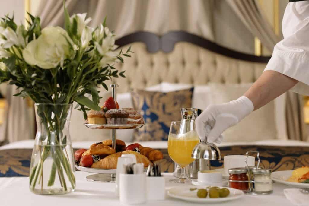 A luxurious room service spread with fresh pastries and fruit, offering an indulgent breakfast for couples on a babymoon