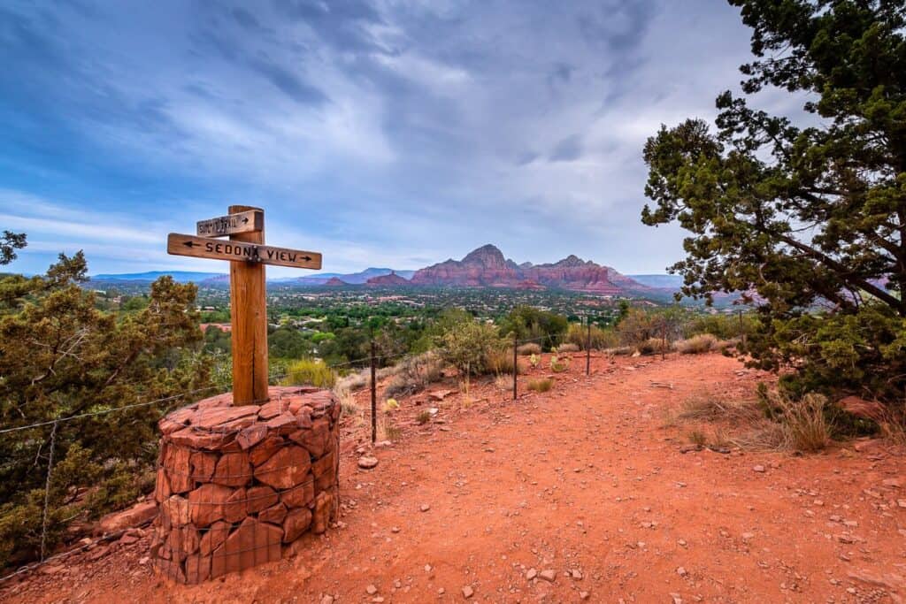 Trail sign pointing to 'Sedona View' at a hiking trail in Sedona, inviting babymooners for a scenic adventure