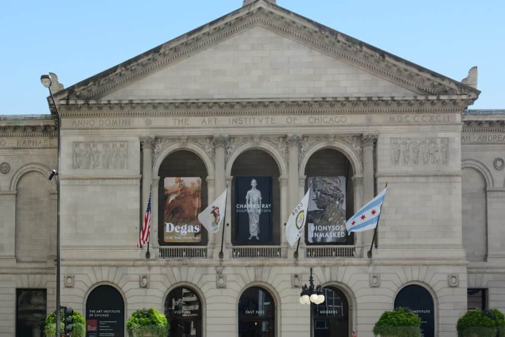 The grand entrance of The Art Institute of Chicago, displaying banners for current exhibits, a cultural excursion for art-loving couples on a babymoon in Chicago