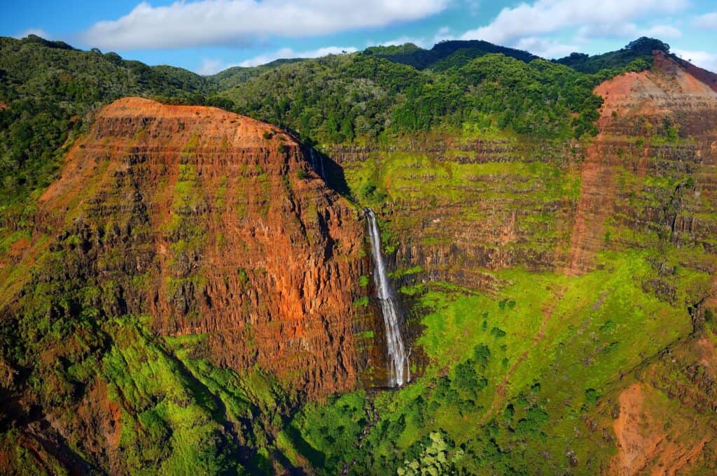 A tall waterfall in Waimean Canyon in Kauai