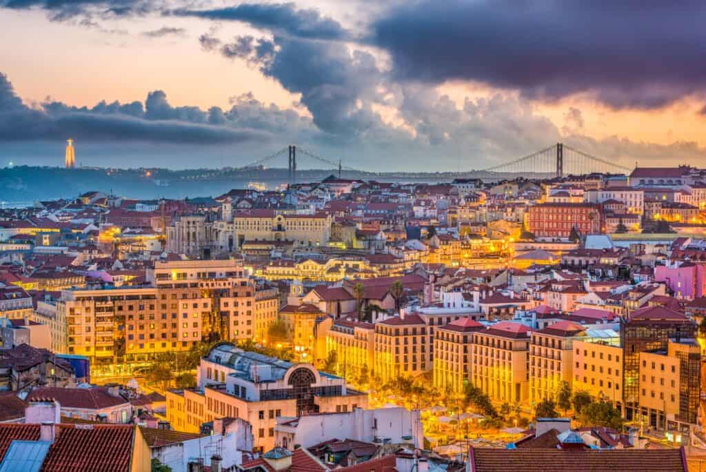 The city skyline of Lisbon at sunset with a golden hint to it.
